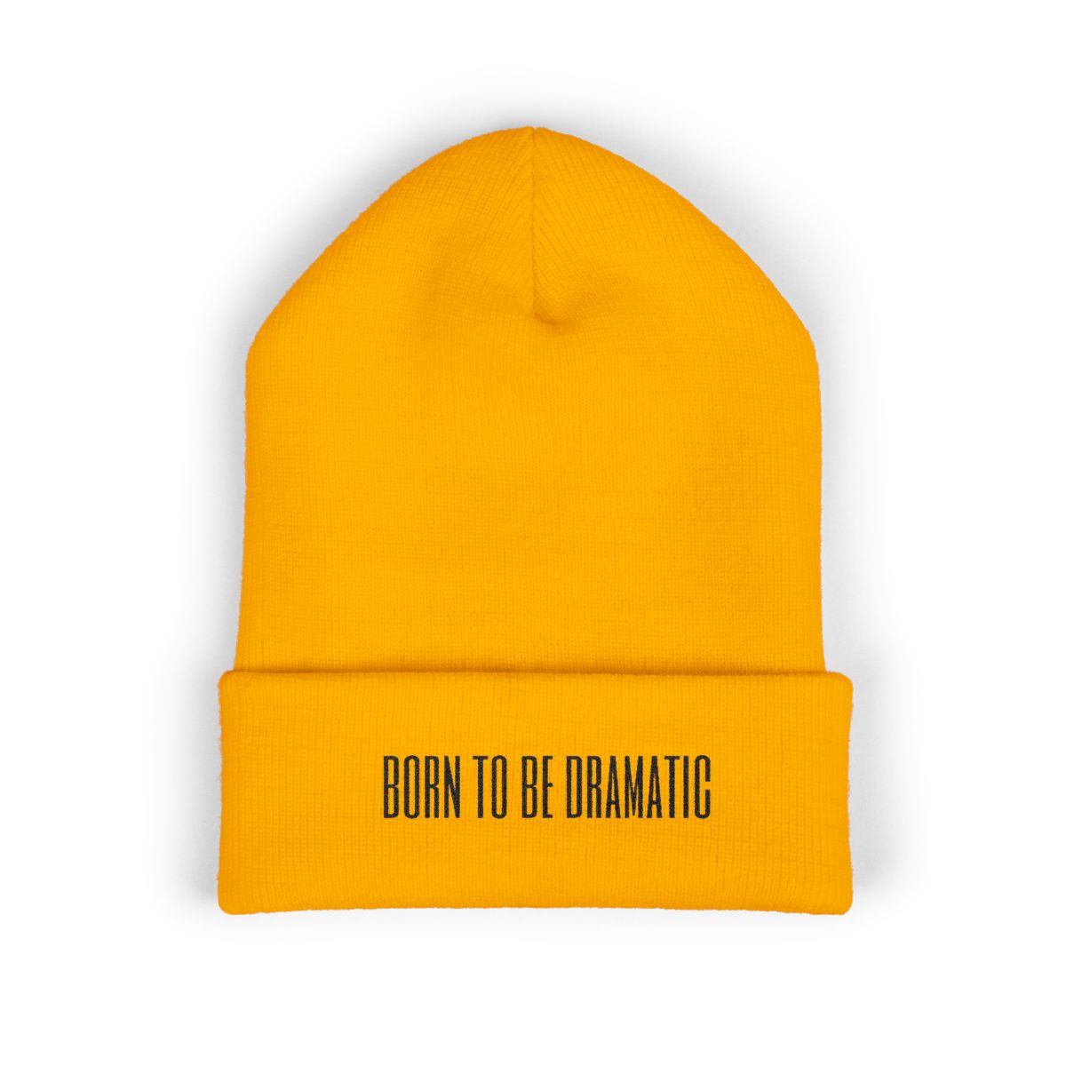 Product mock-up of Born to Be Dramatic — Embroidered Cuffed Beanie in Gold.